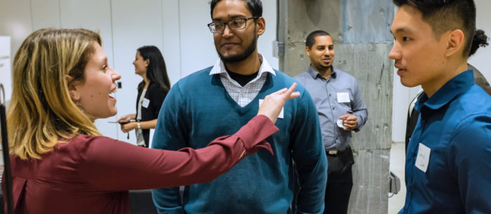 A group of young professionals chat.