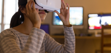 A girl playing with a virtual reality headset.