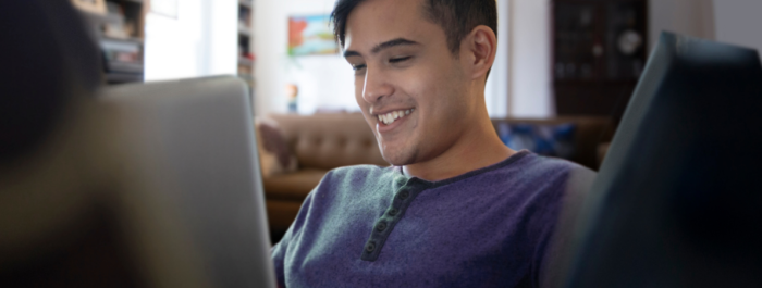 A young man working on a laptop.