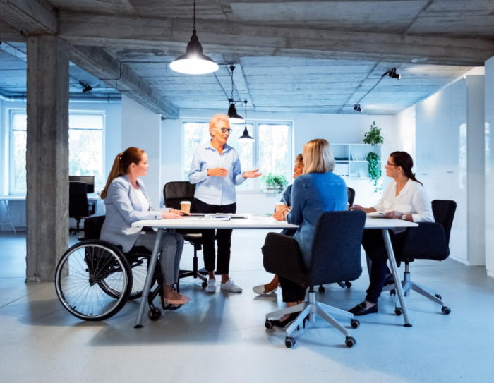 Four people have a meeting together.