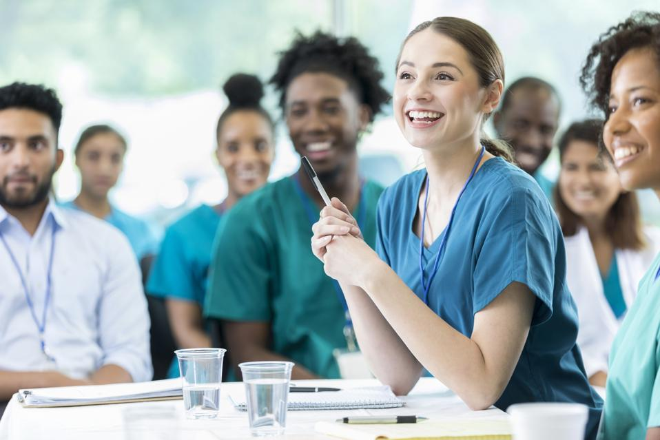 Stock image of a woman in the medical field smiling.